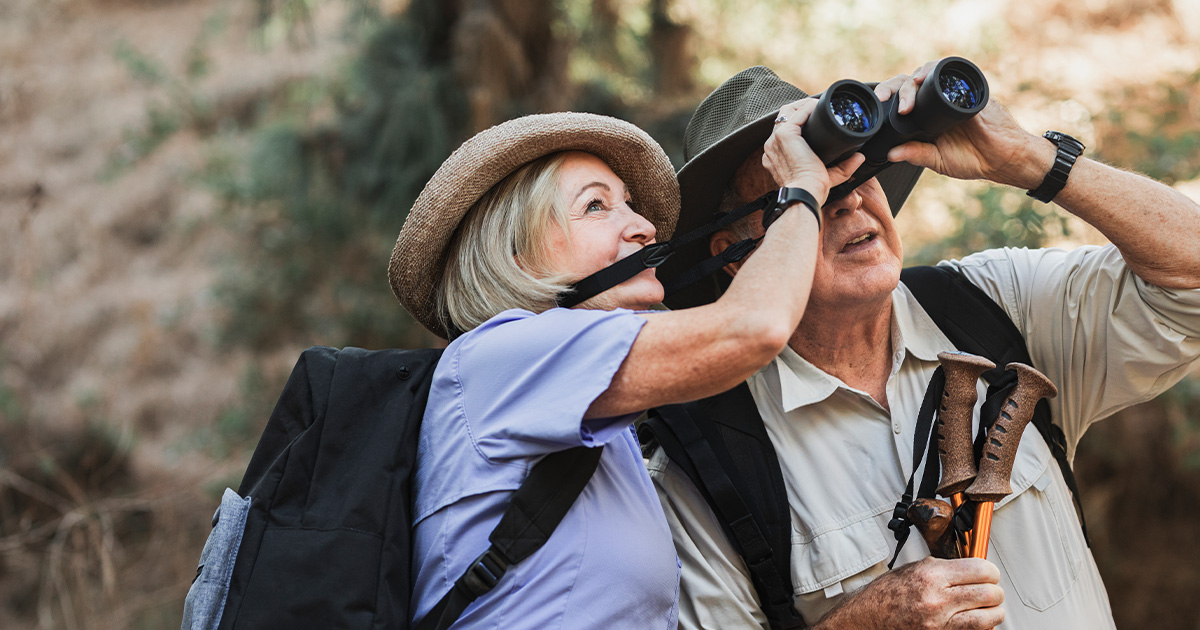 Couple bird watching together with binoculars