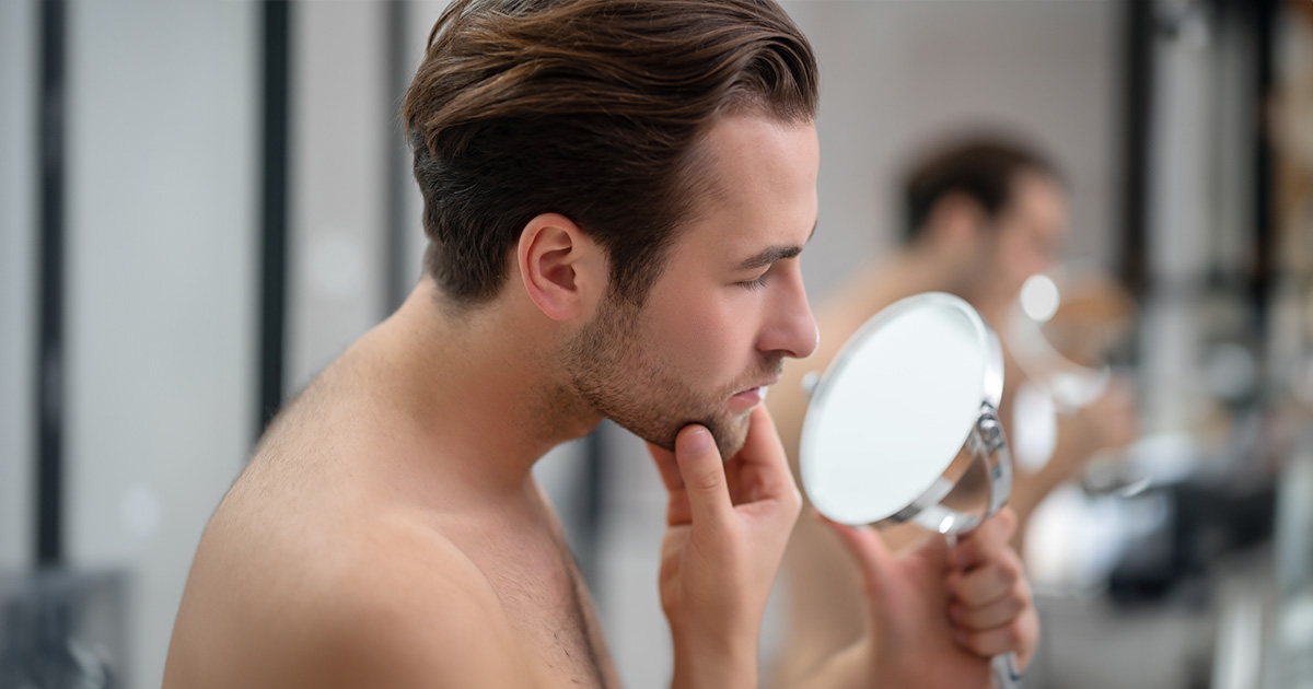 man looking in mirror